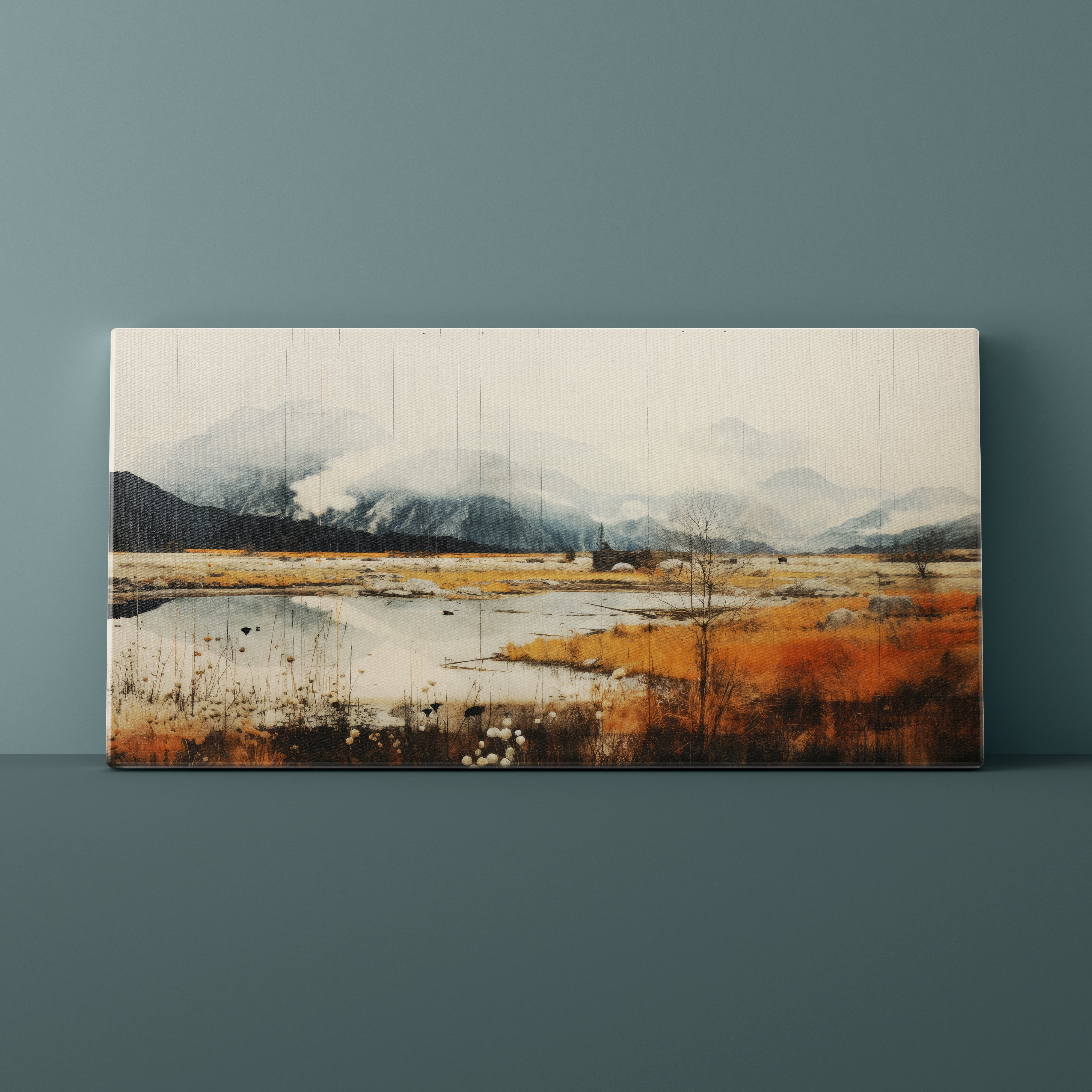 Canvas print of a landscape with mountains and a field on a gray wall.
