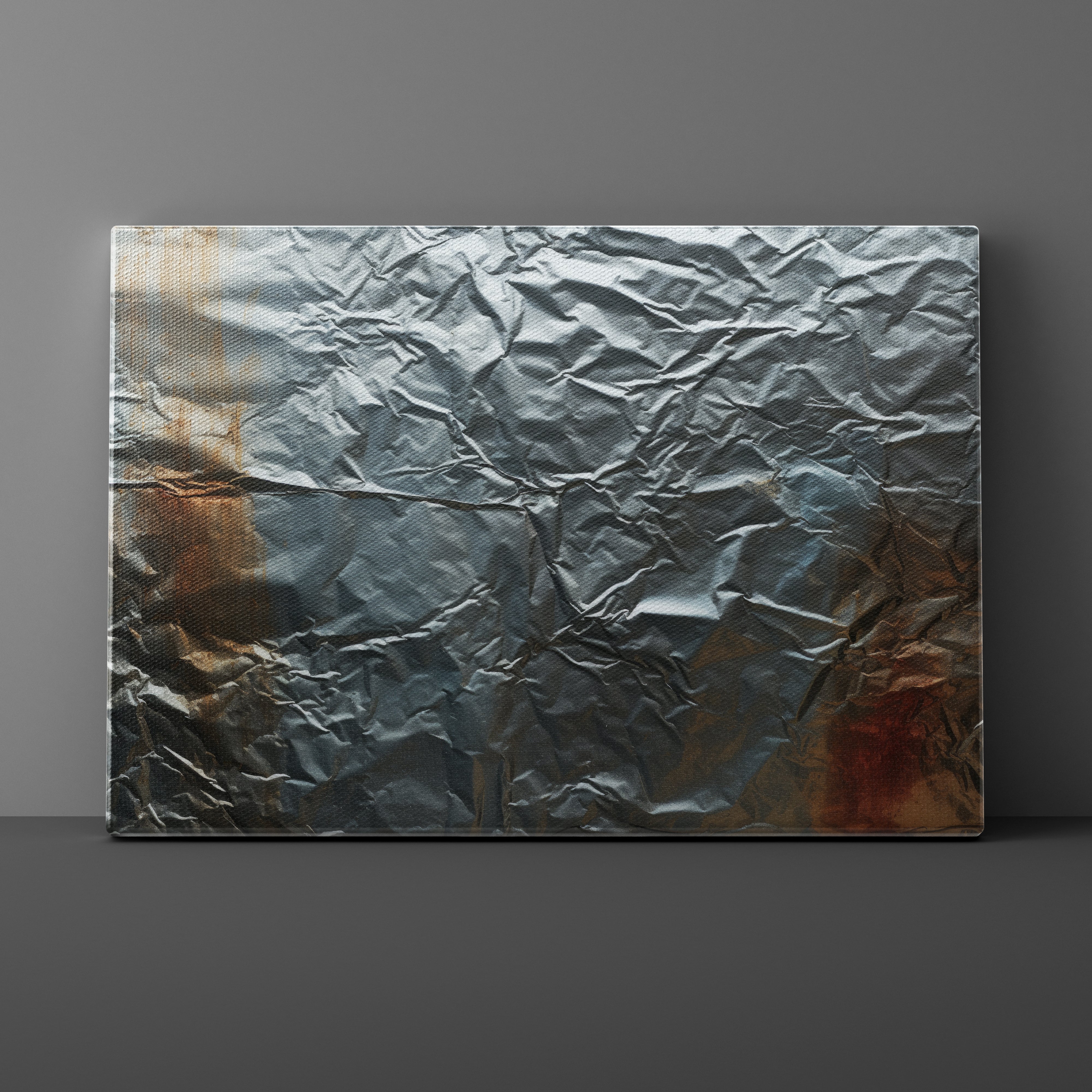 Textured metal panel with crumpled effect on a gray background