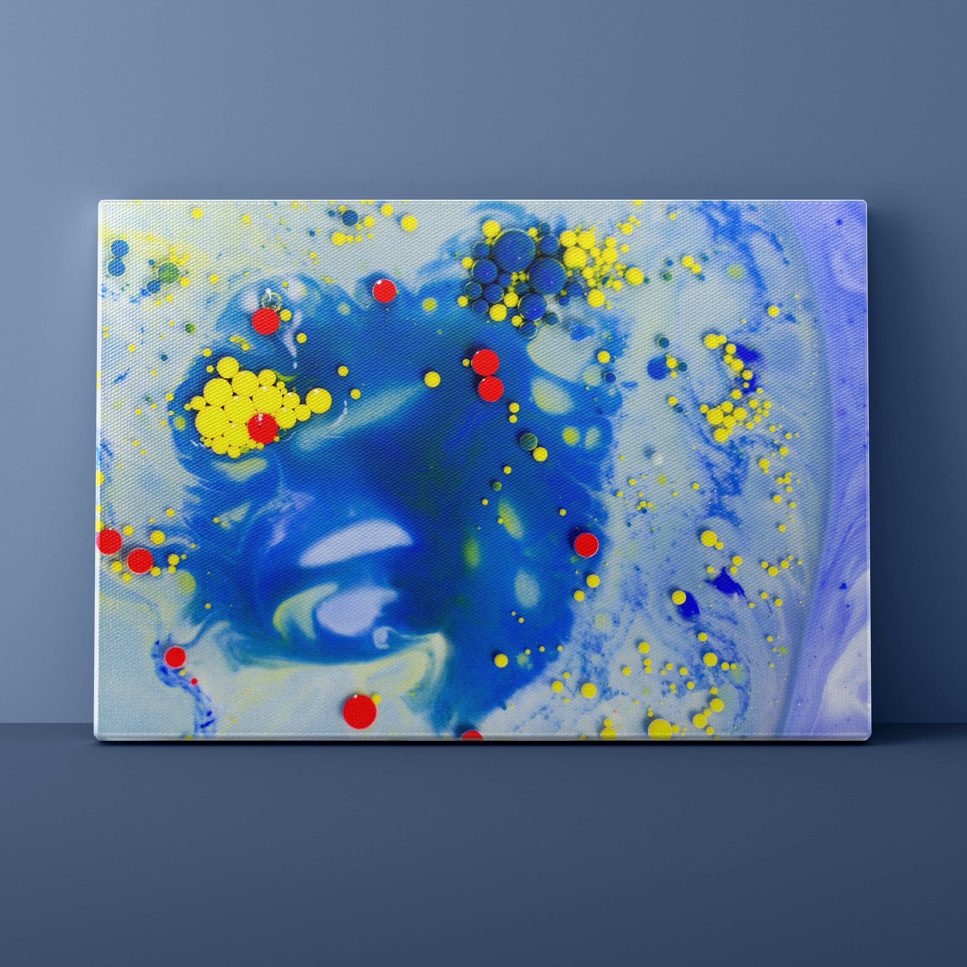 Abstract art piece with blue, yellow, and red splashes on a dark gray background