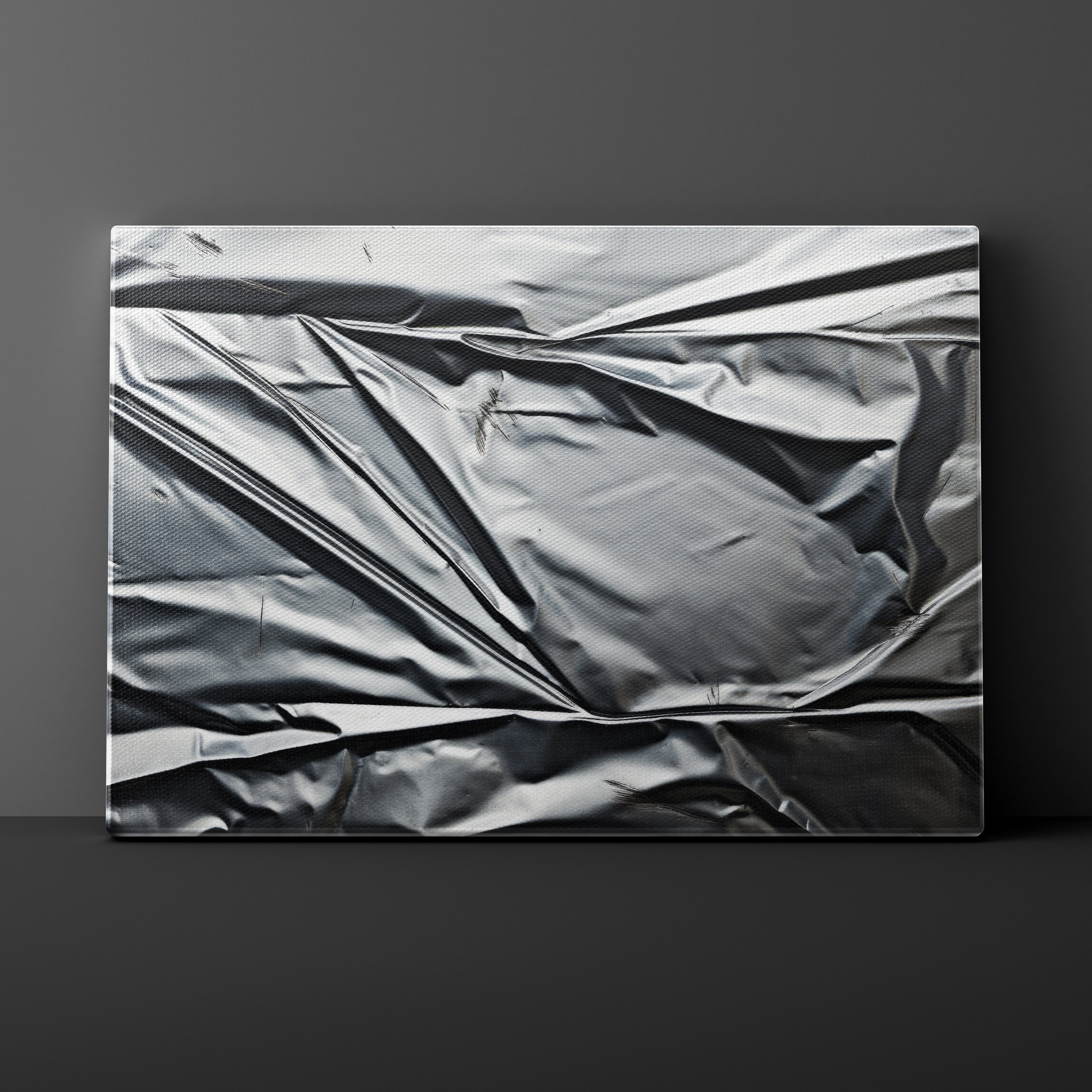 Metallic crumpled foil on a dark gray background