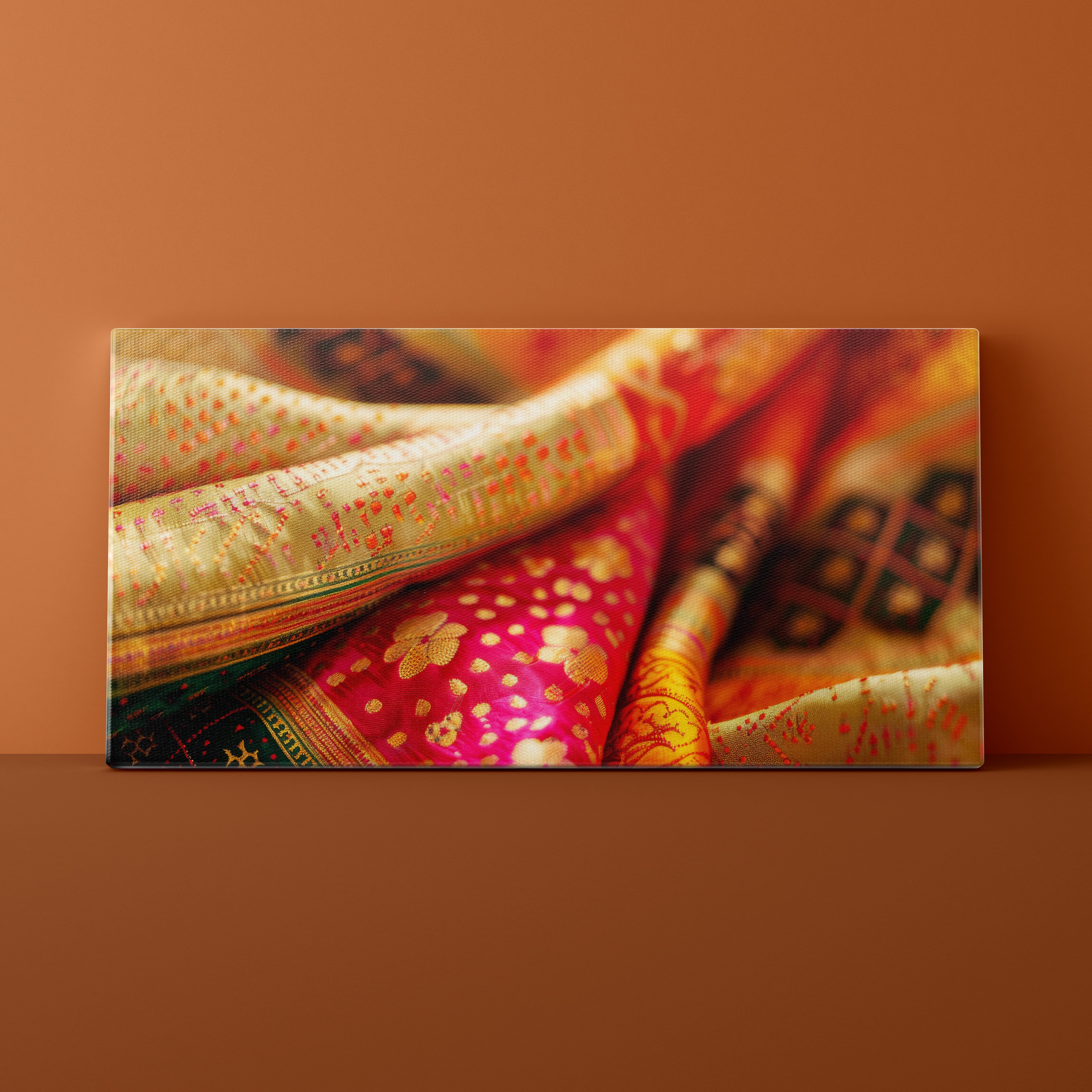 Colorful sarees arranged on a brown surface with a matching background