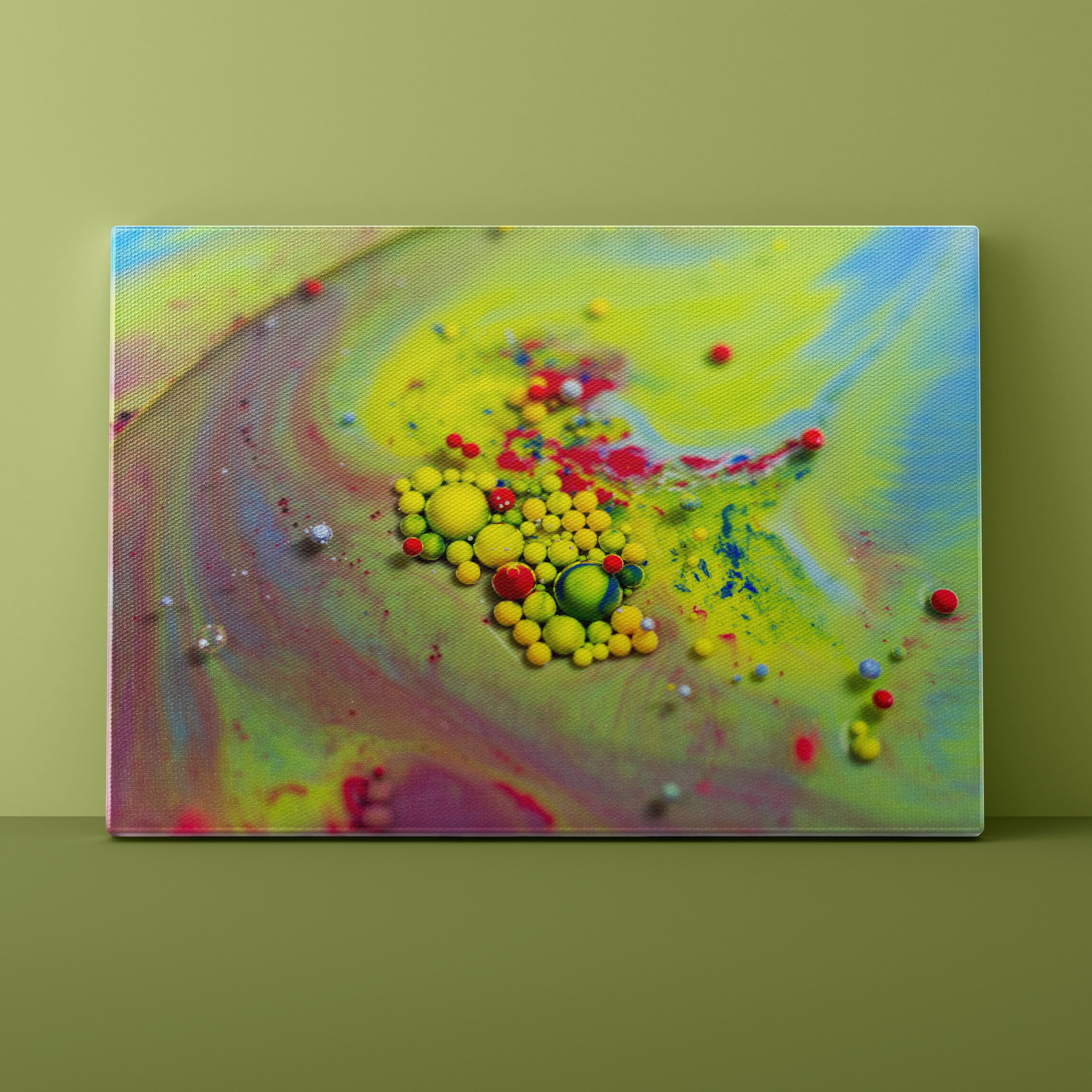 Colorful abstract painting with spherical elements on a green wall