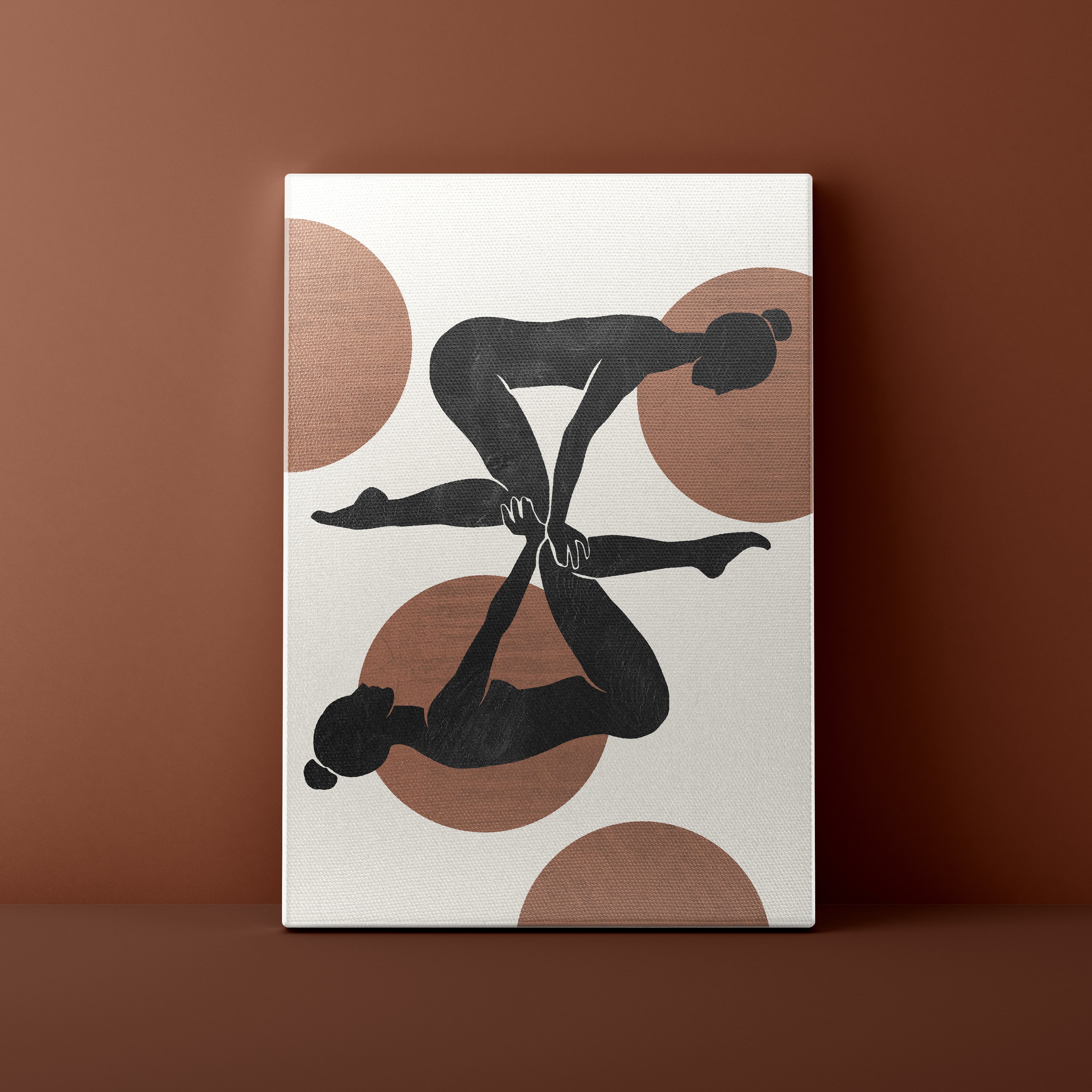 Canvas print with abstract design of two black figures and brown circles on a beige background, against a brown wall.