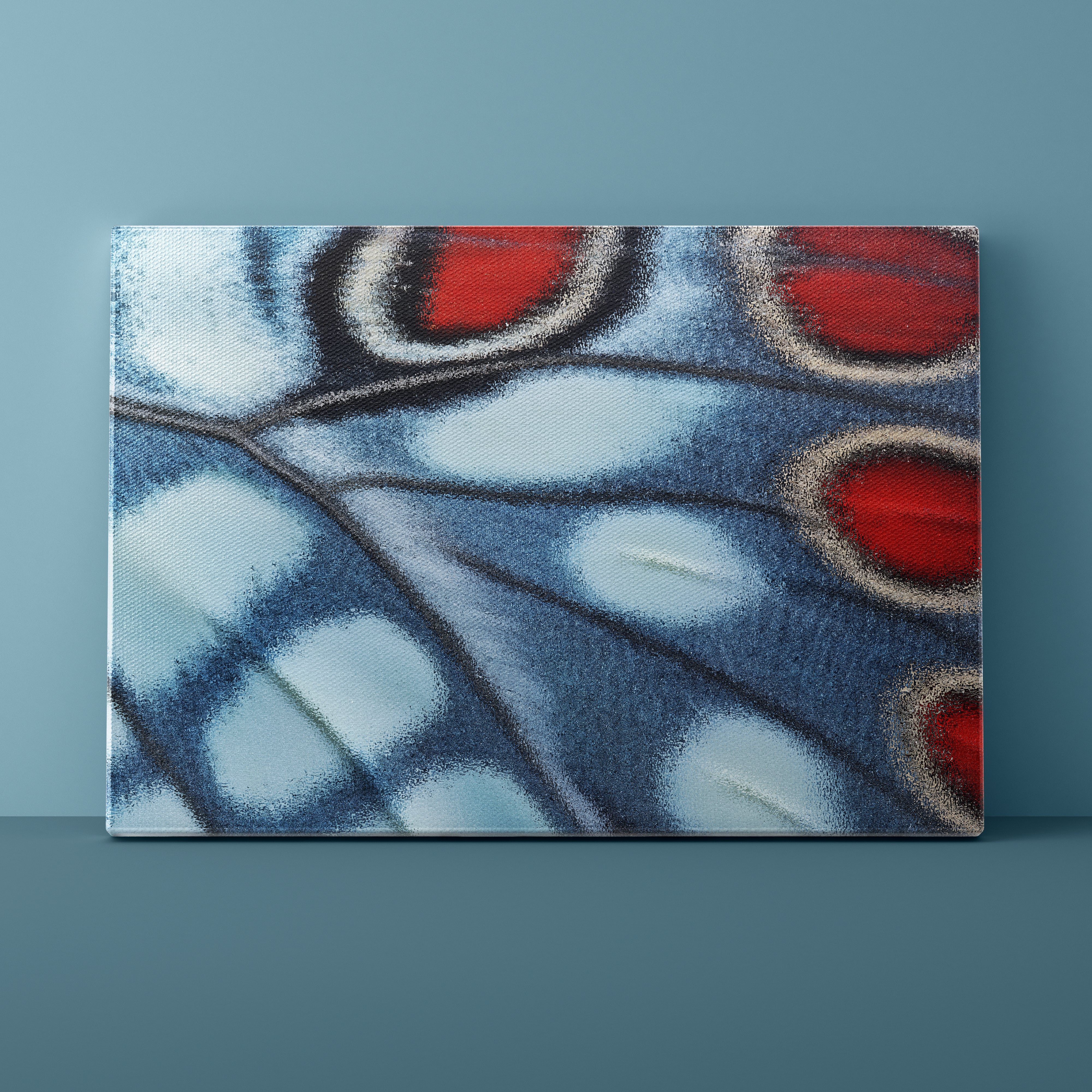 Close-up of a butterfly wing with blue, red, and black patterns on a blue background