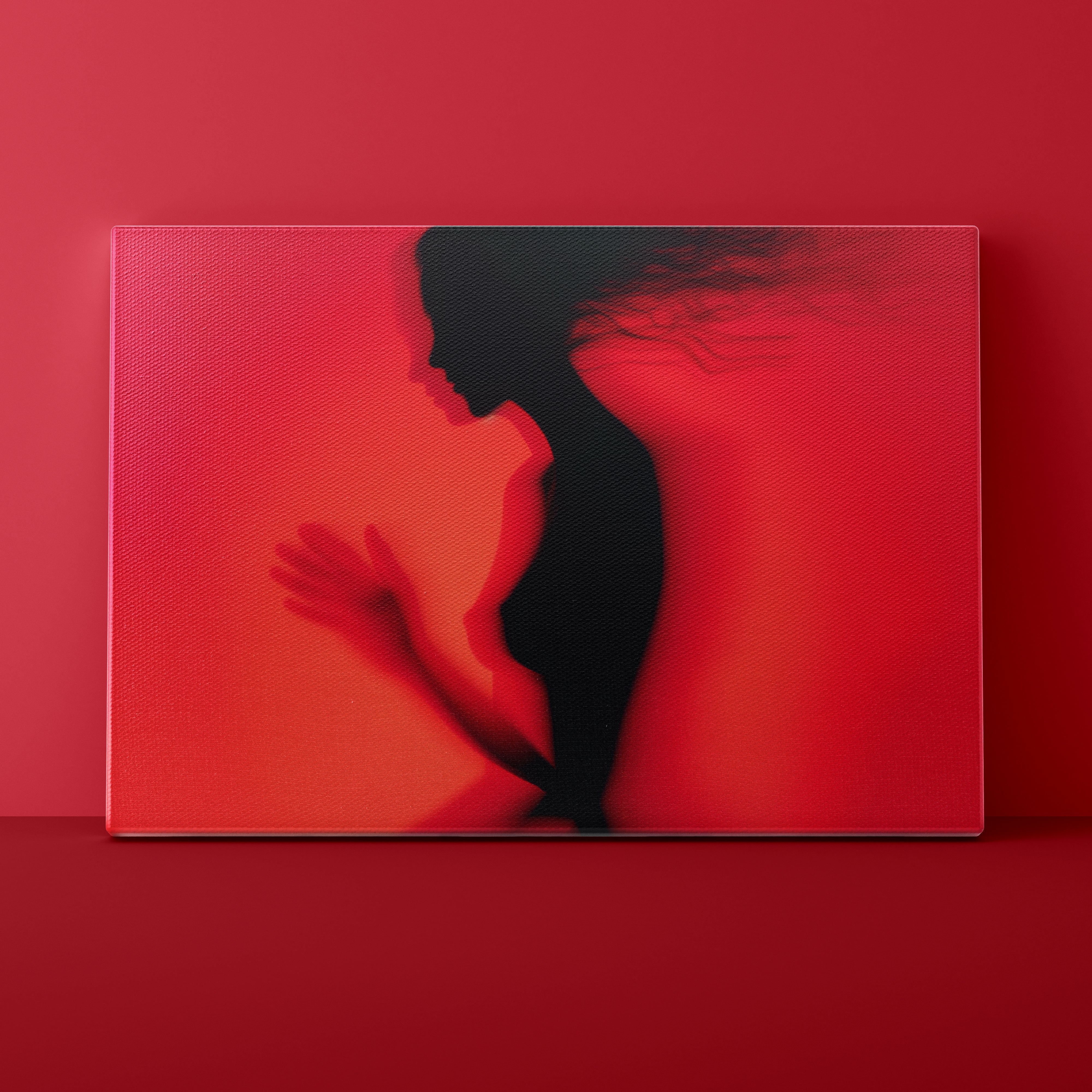 Silhouette of a person embracing another against a red background