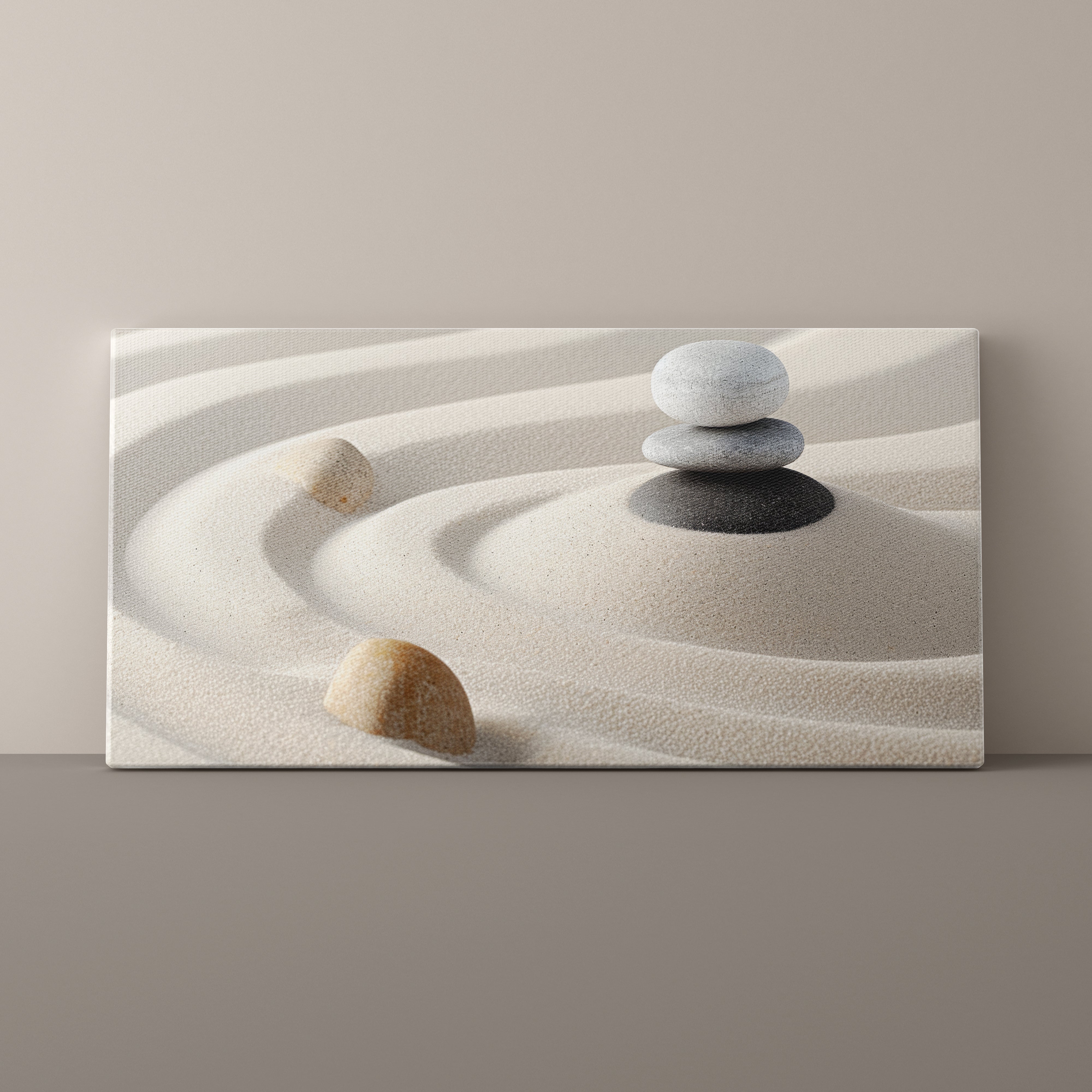 Canvas print of stacked stones on sand with a minimalistic design.