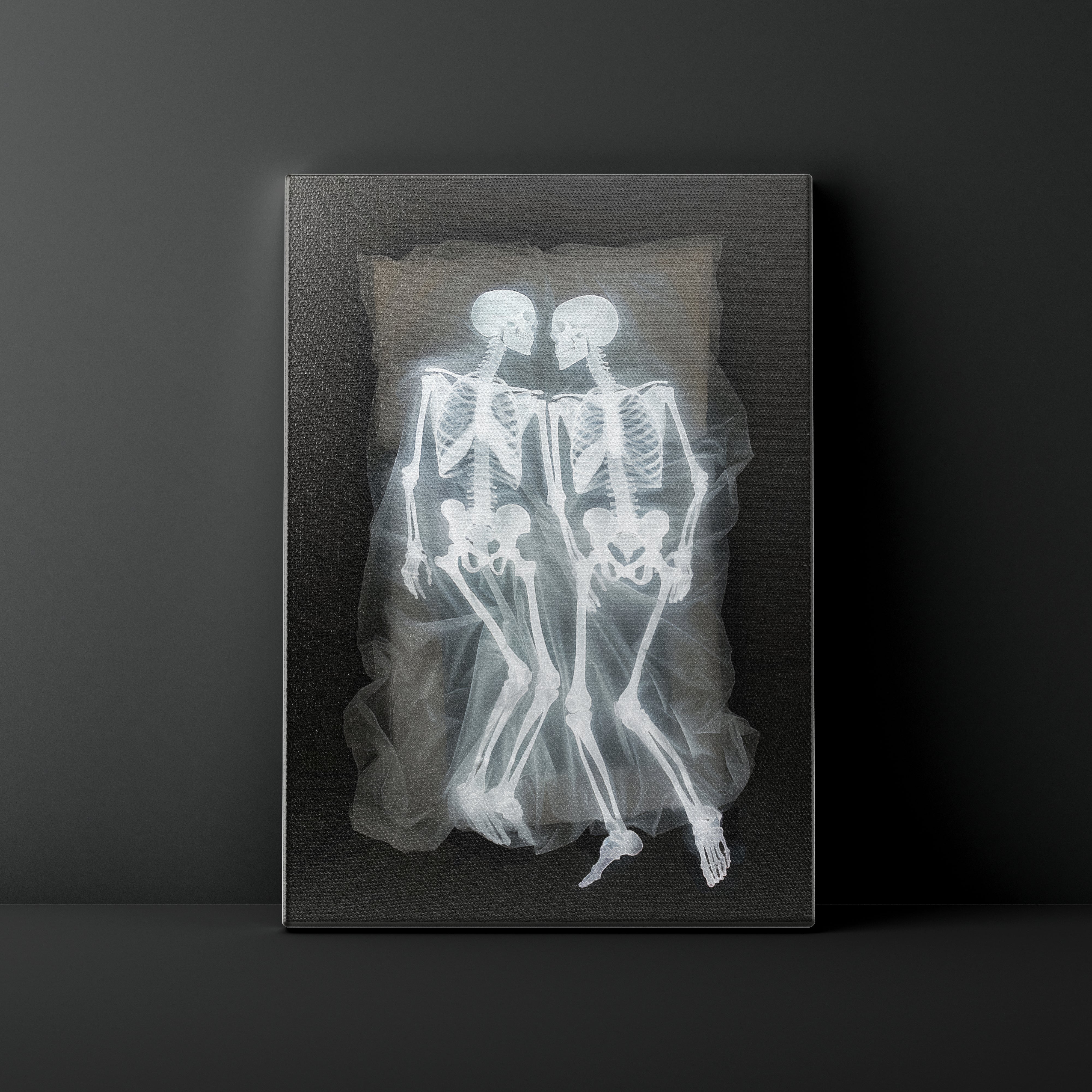 X-ray of two skeletons embracing on a dark background