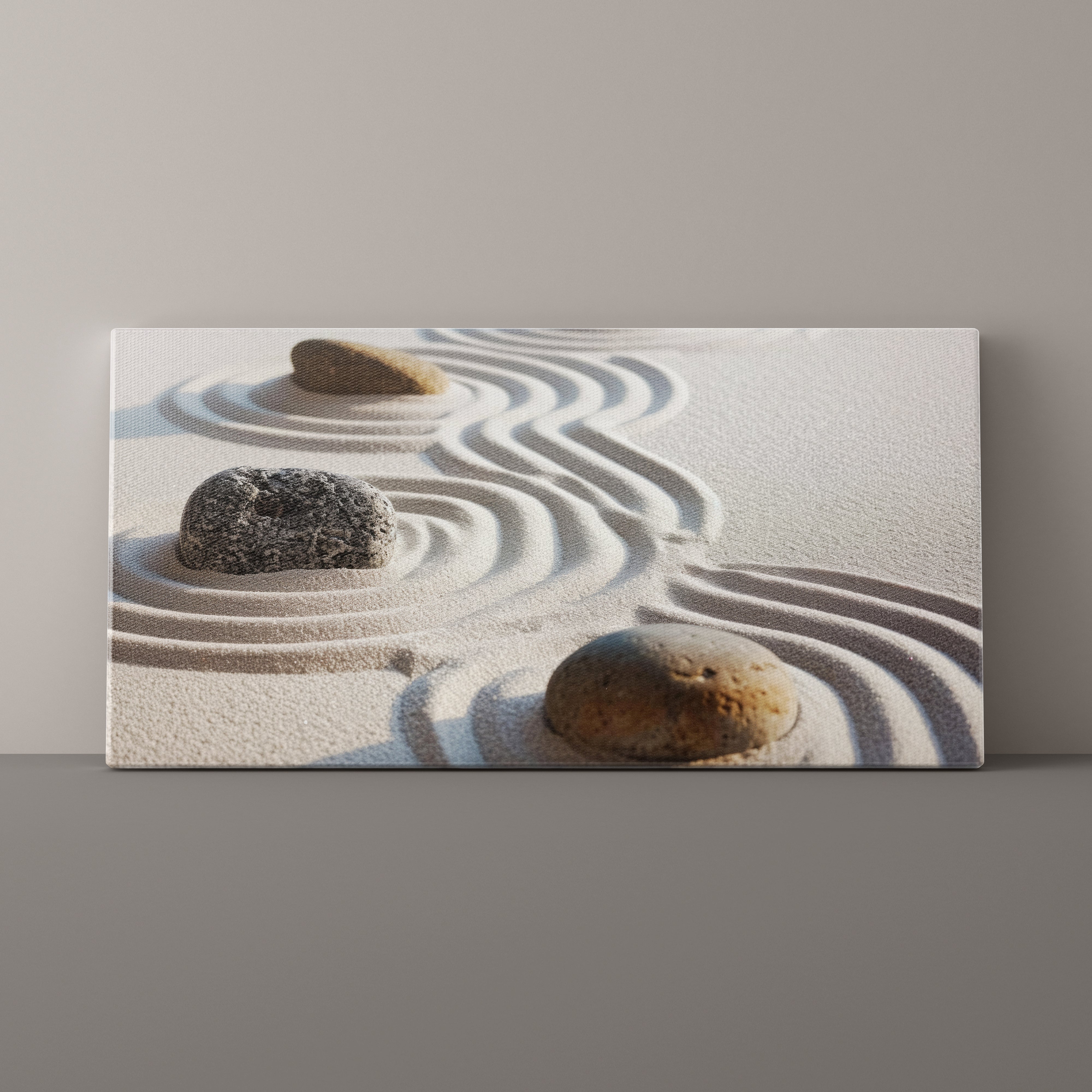 Canvas print of a minimalist scene with stones and sand on a plain background