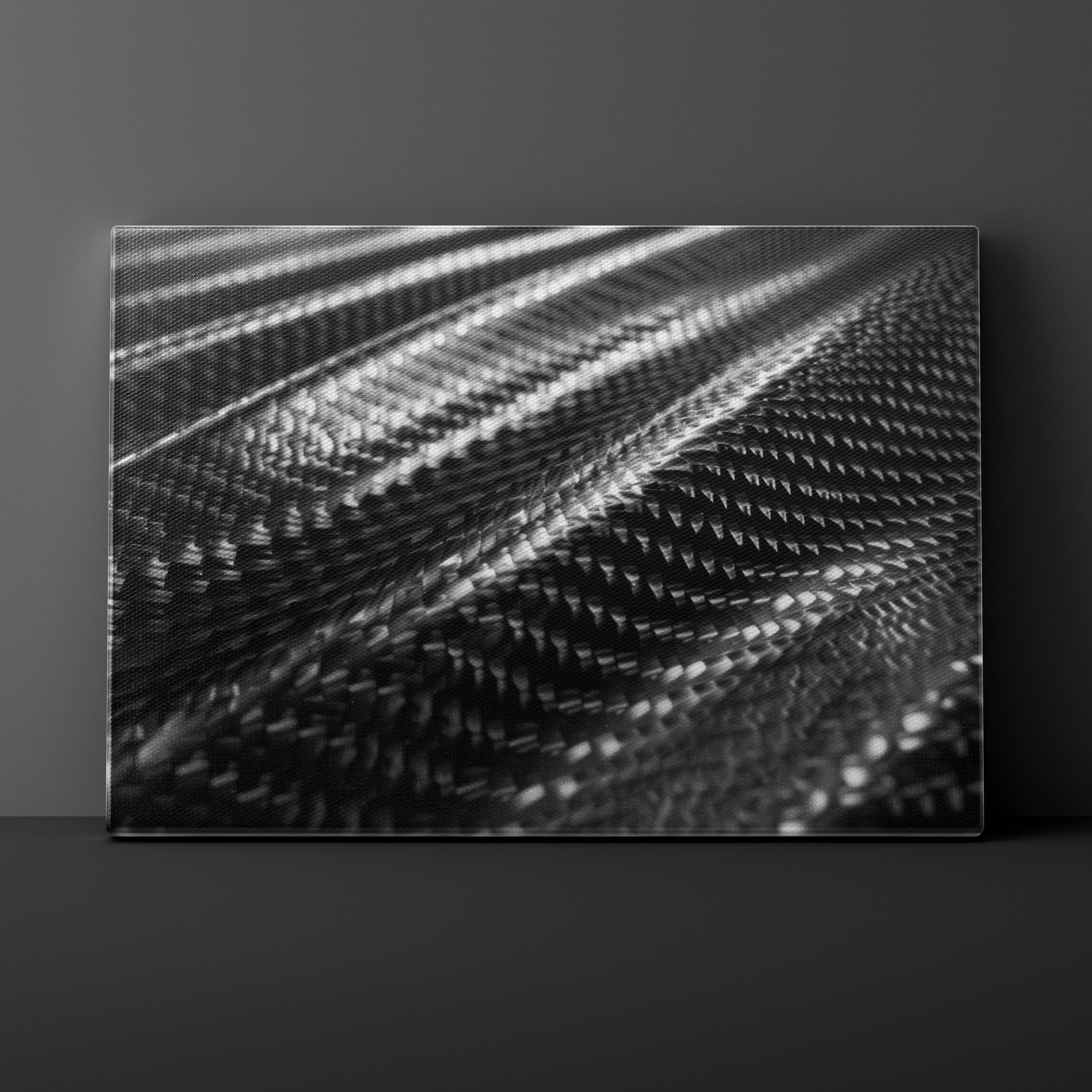 Abstract black and white pattern on a textured surface against a dark gray background