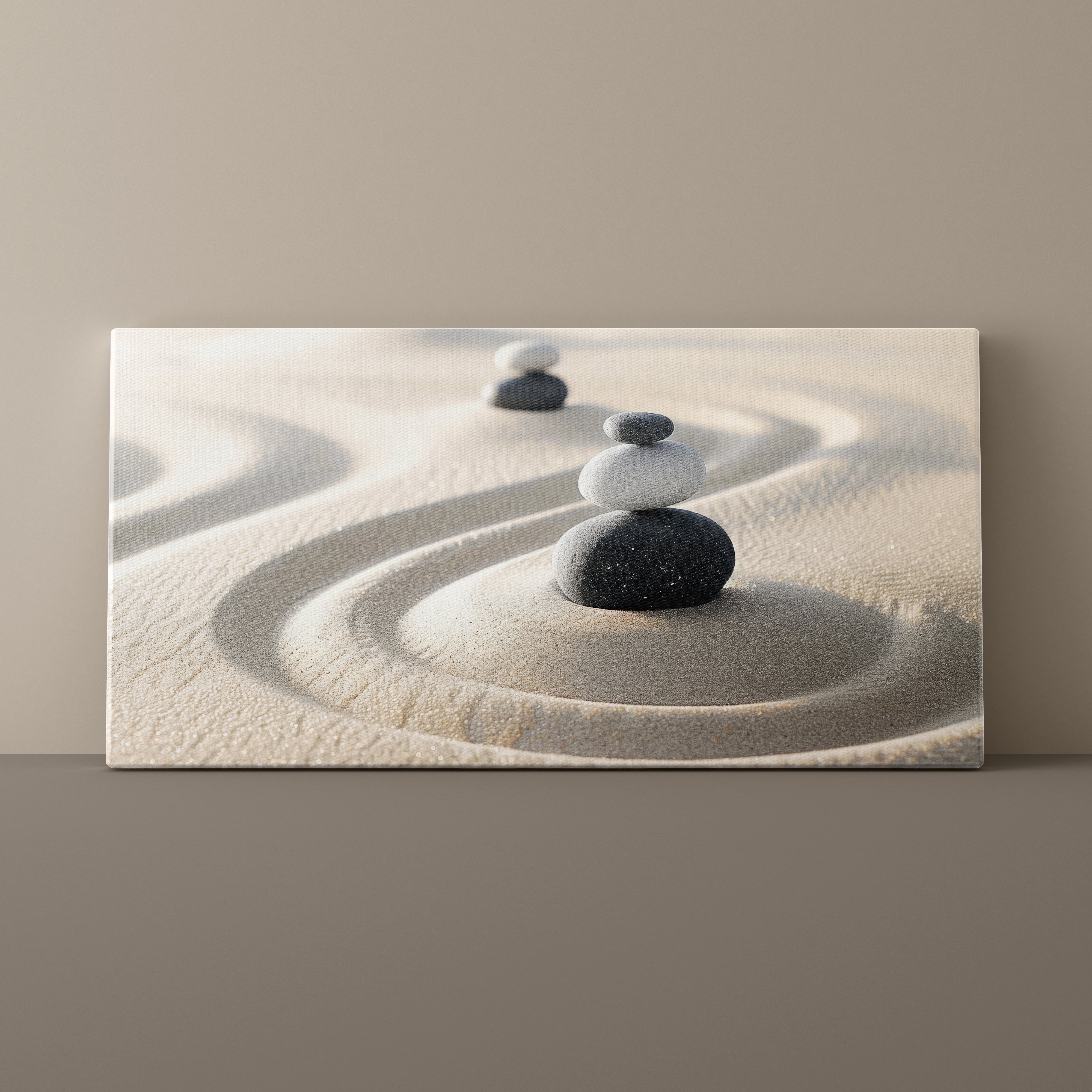 Canvas print of stacked stones on sand against a beige wall