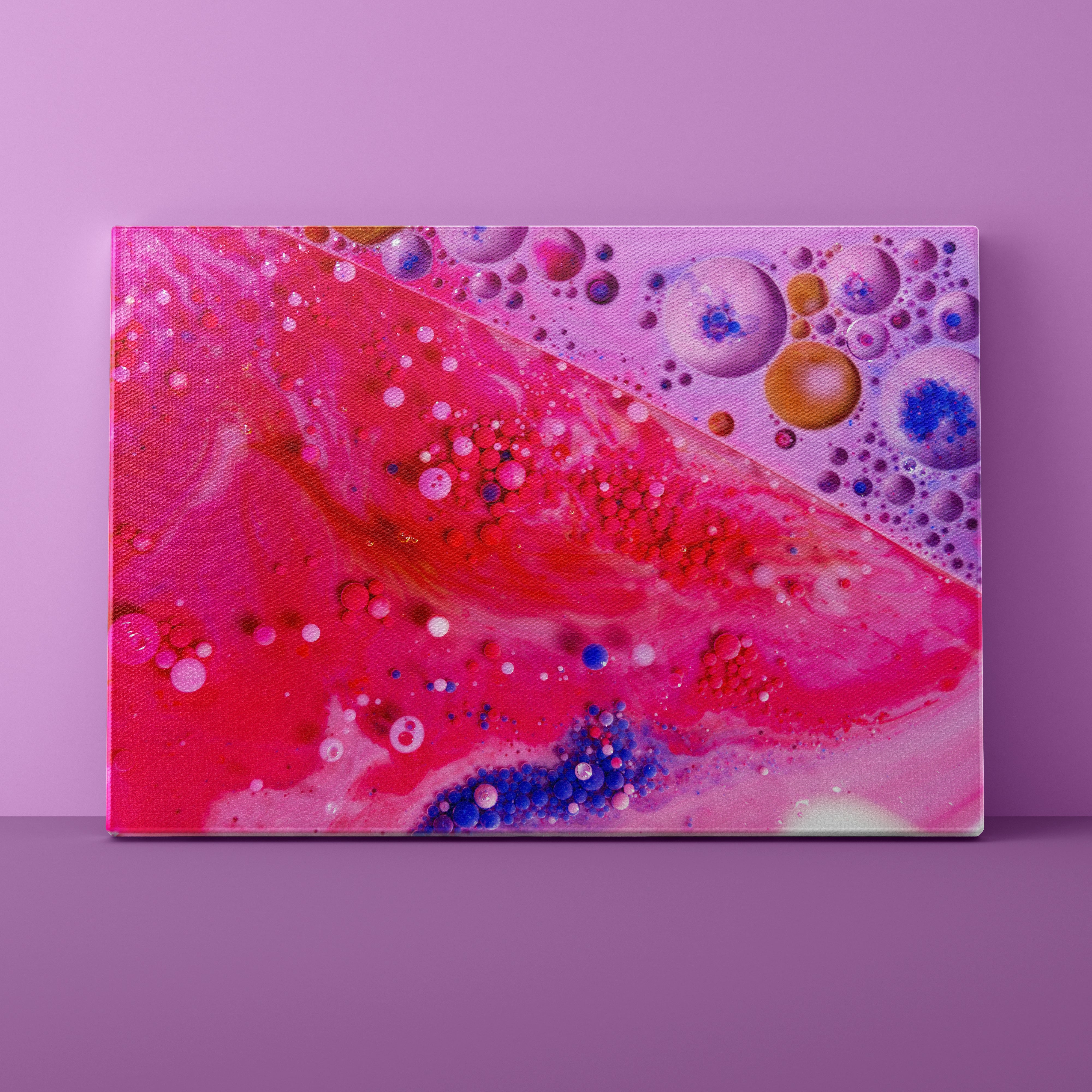 Abstract art piece with colorful bubbles on a pink background