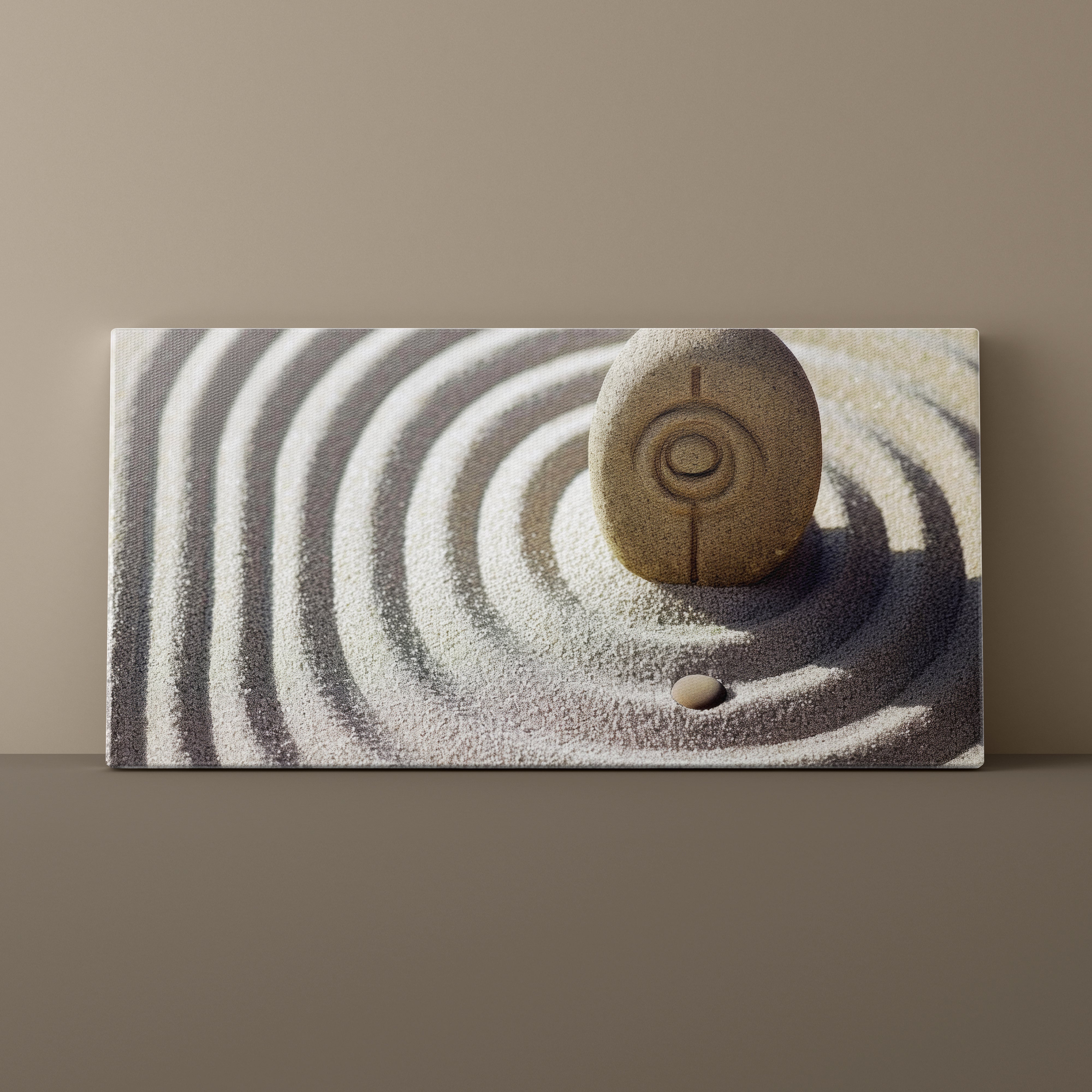Canvas print of a stone in sand with concentric circles on a beige background