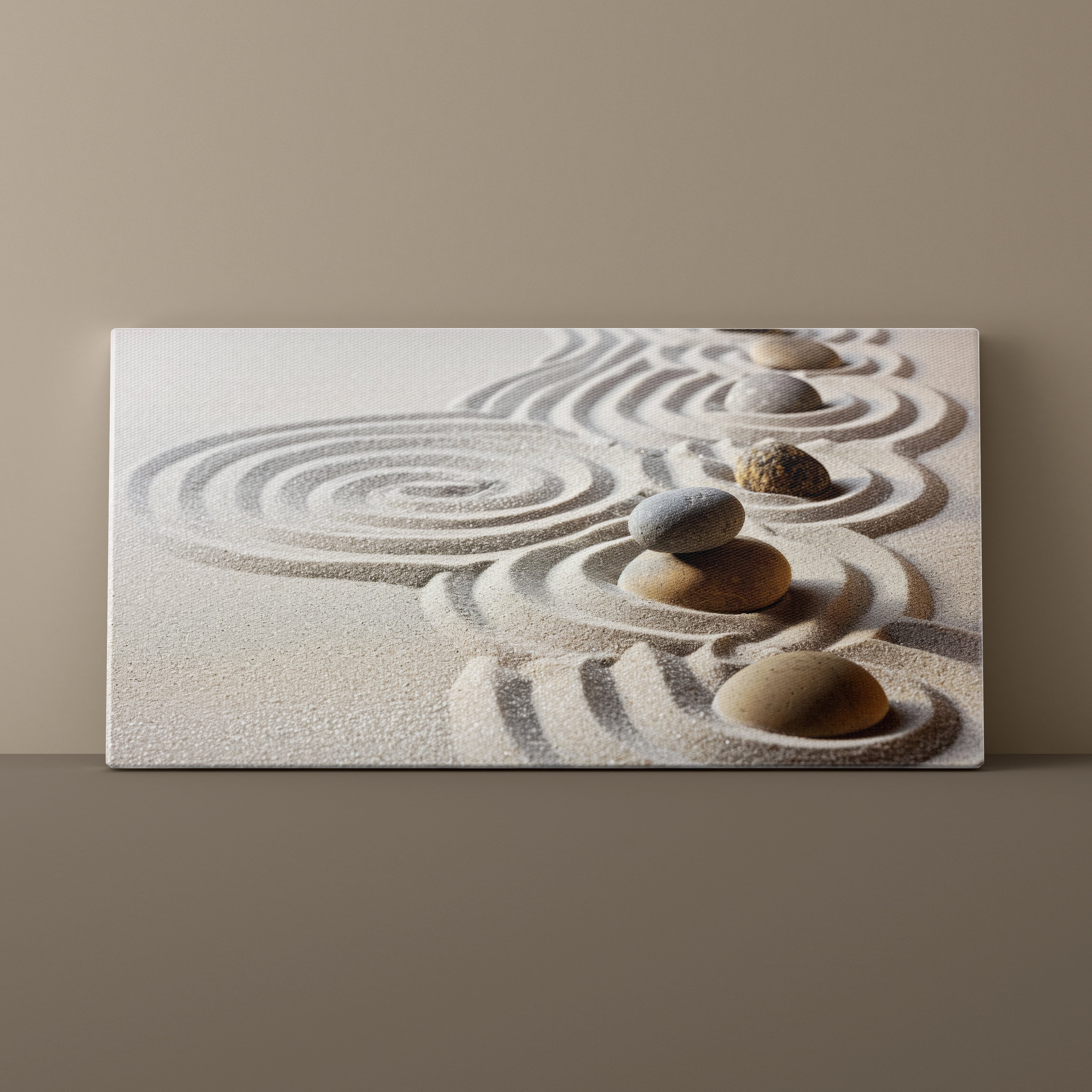 Canvas print of a zen garden with stones and sand on a beige wall.