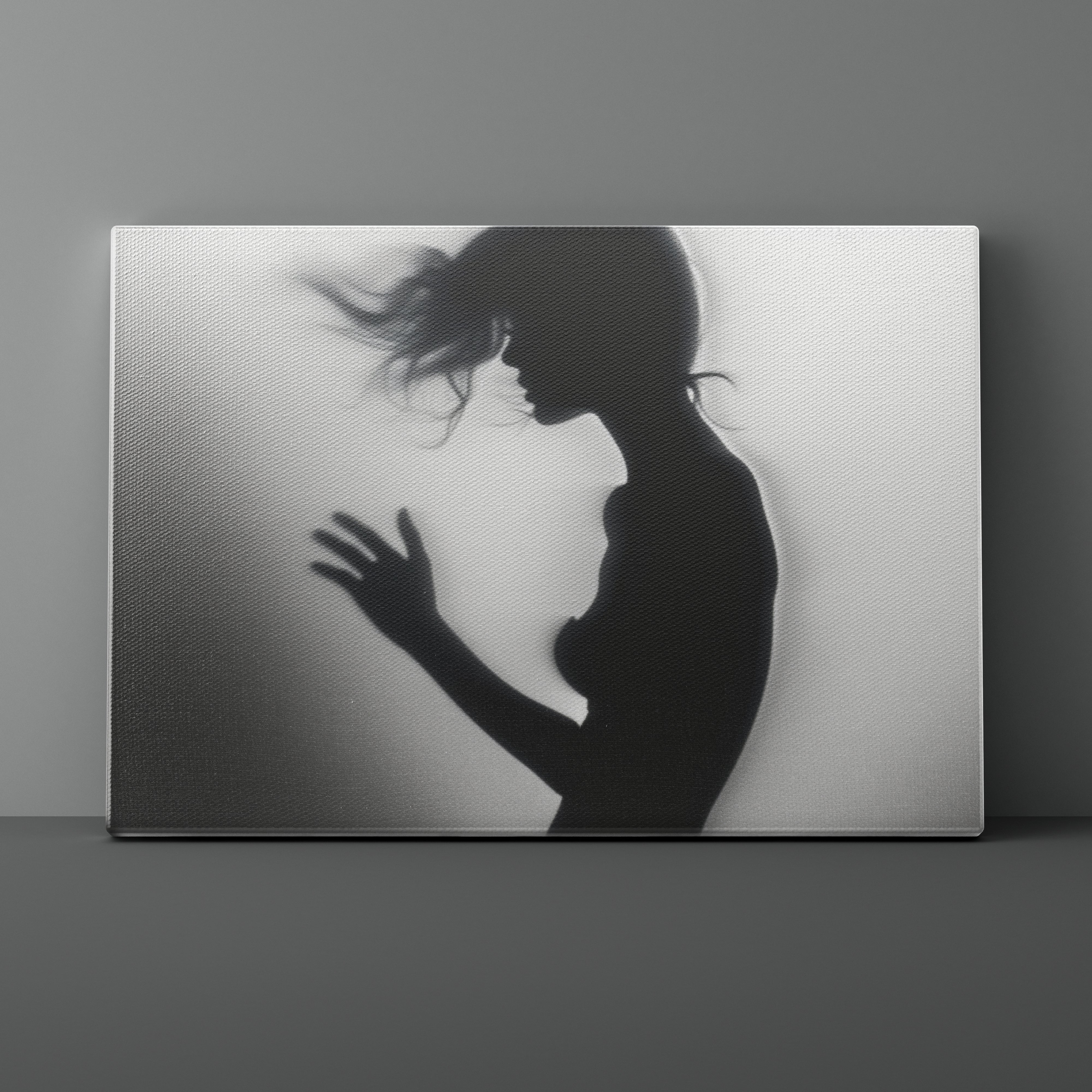 Silhouette of a woman against a textured wall on a gray background