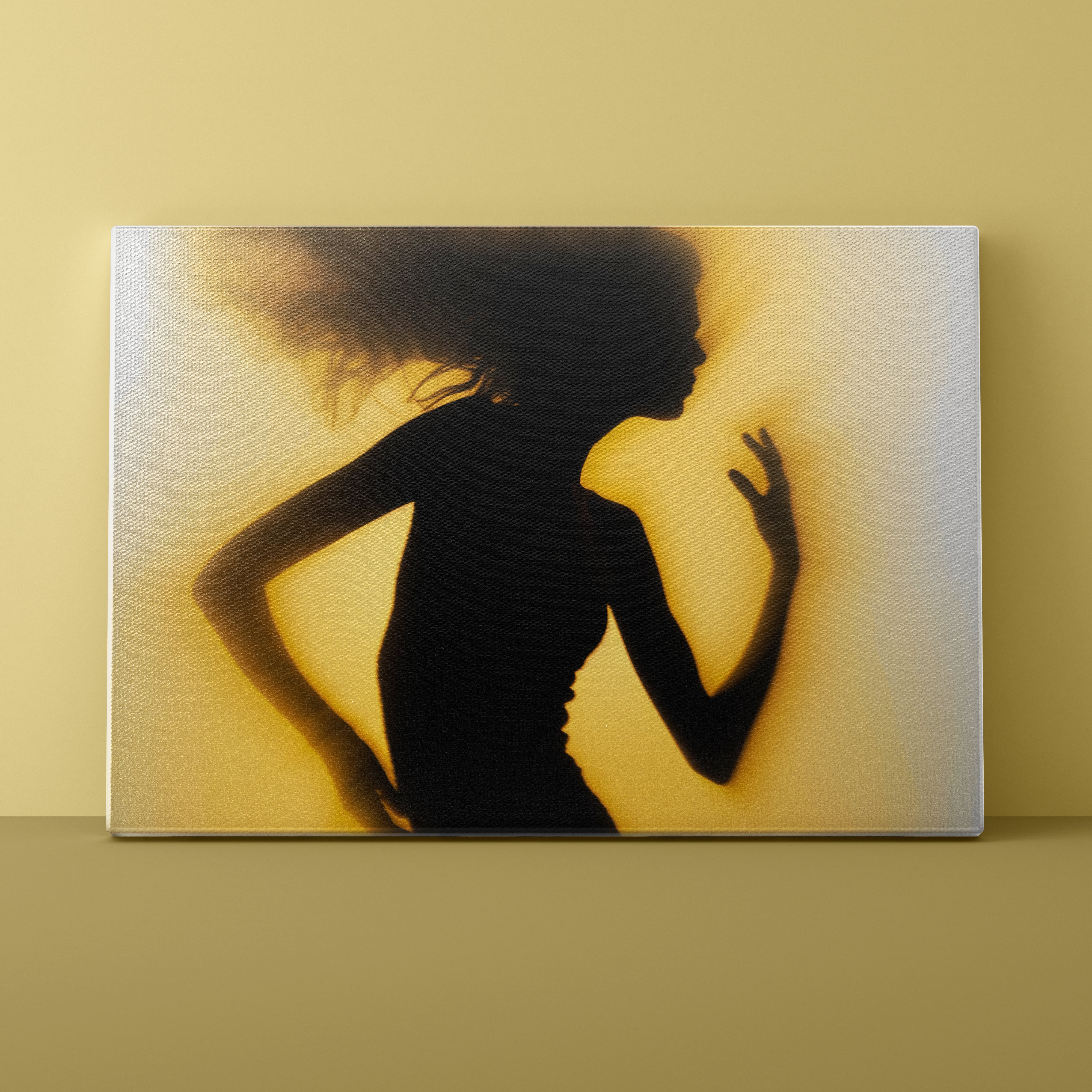 Silhouette of a woman against a yellow background on a framed artwork.