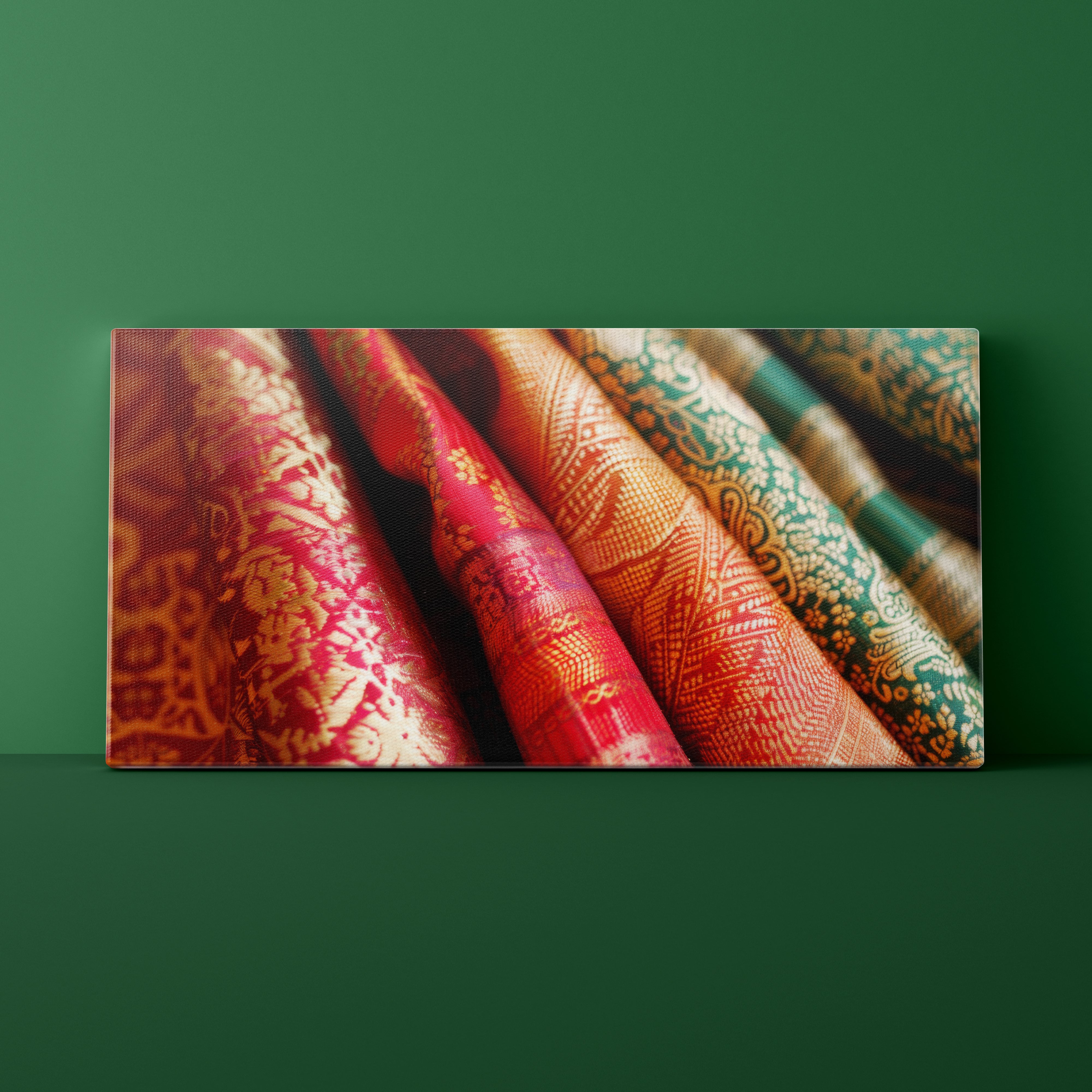 Canvas print of patterned fabric rolls on a green background