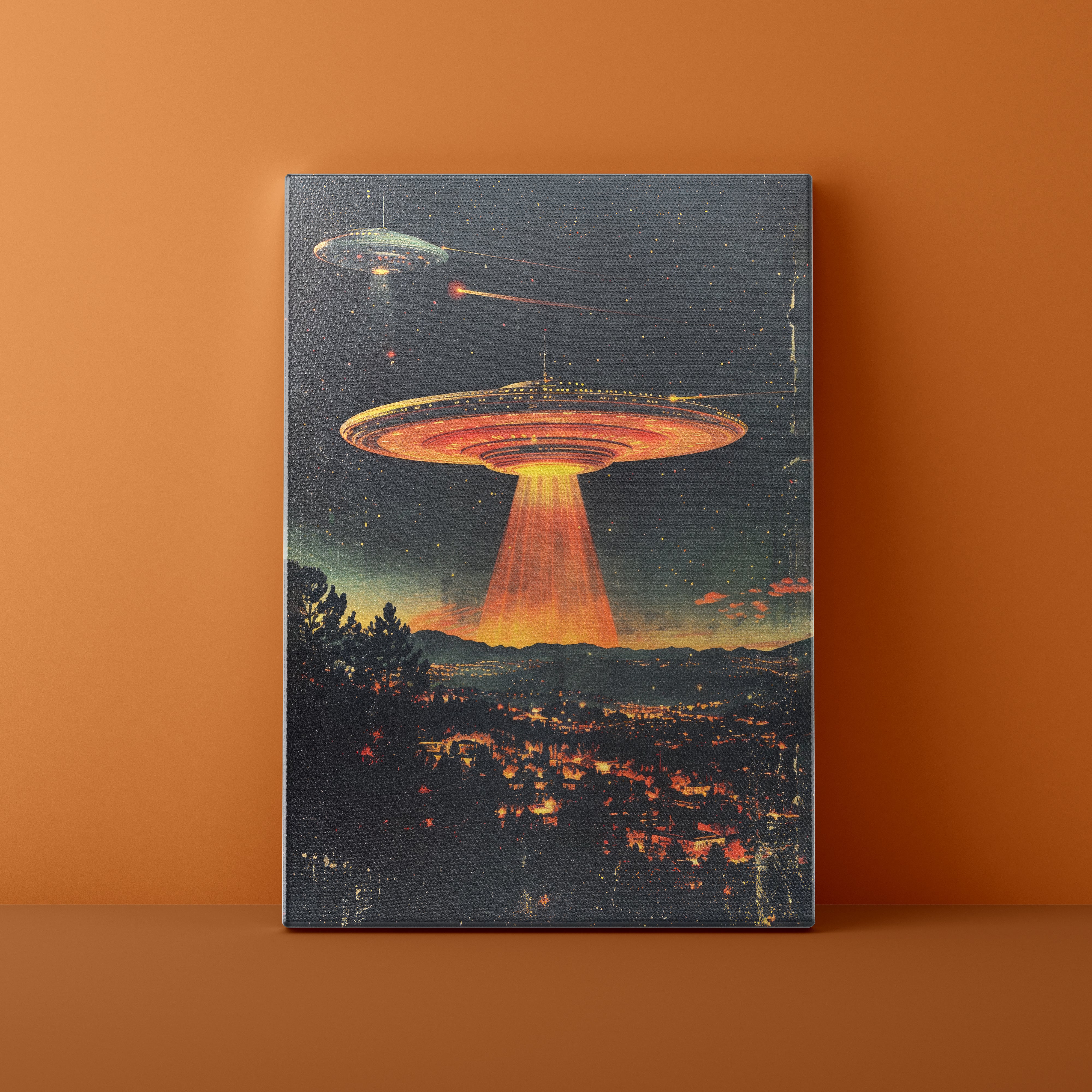 Canvas print of a UFO over a city with a starry night sky on an orange wall.
