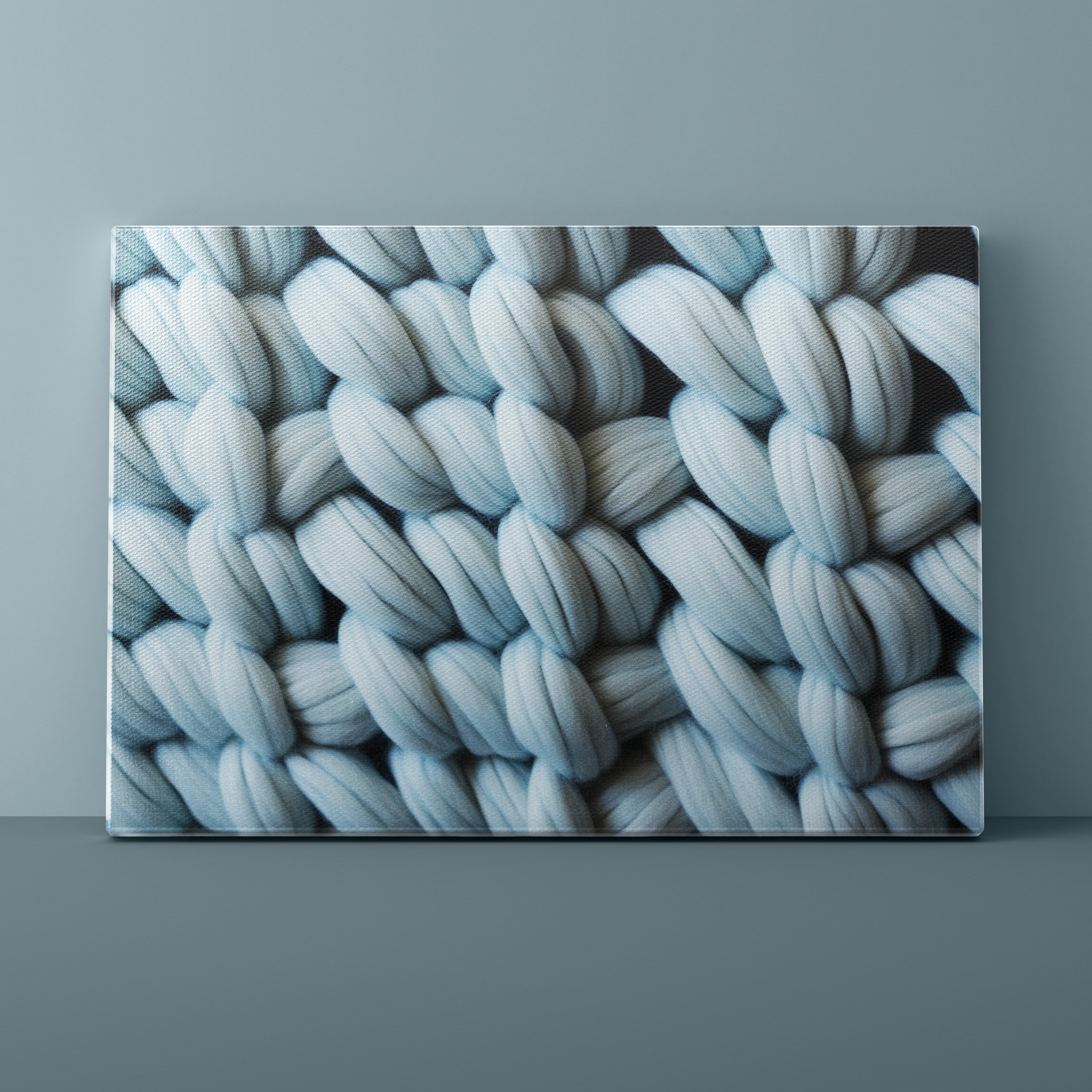 Canvas print of a textured blue pattern on a gray wall