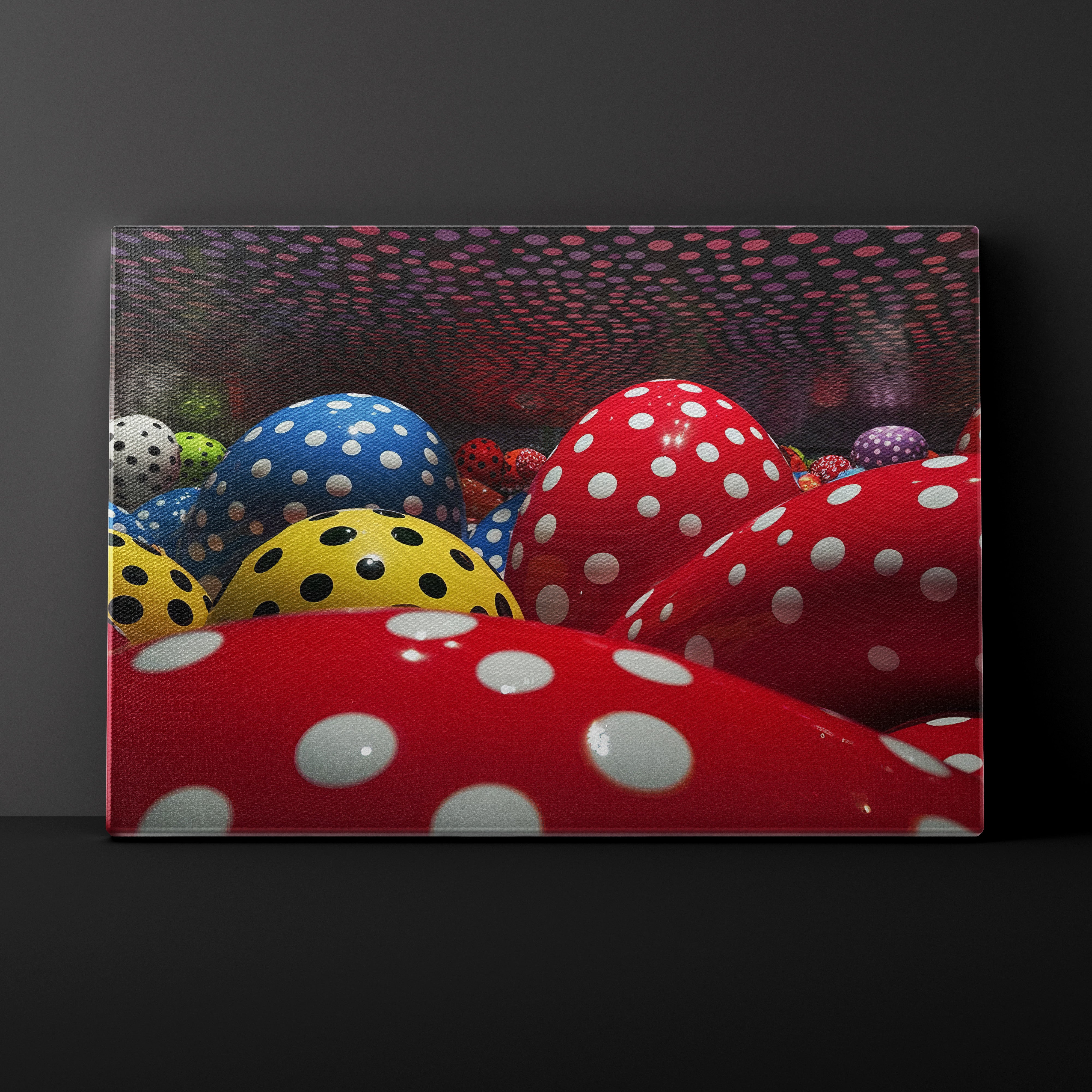 Canvas print of colorful polka dot balls against a dark background