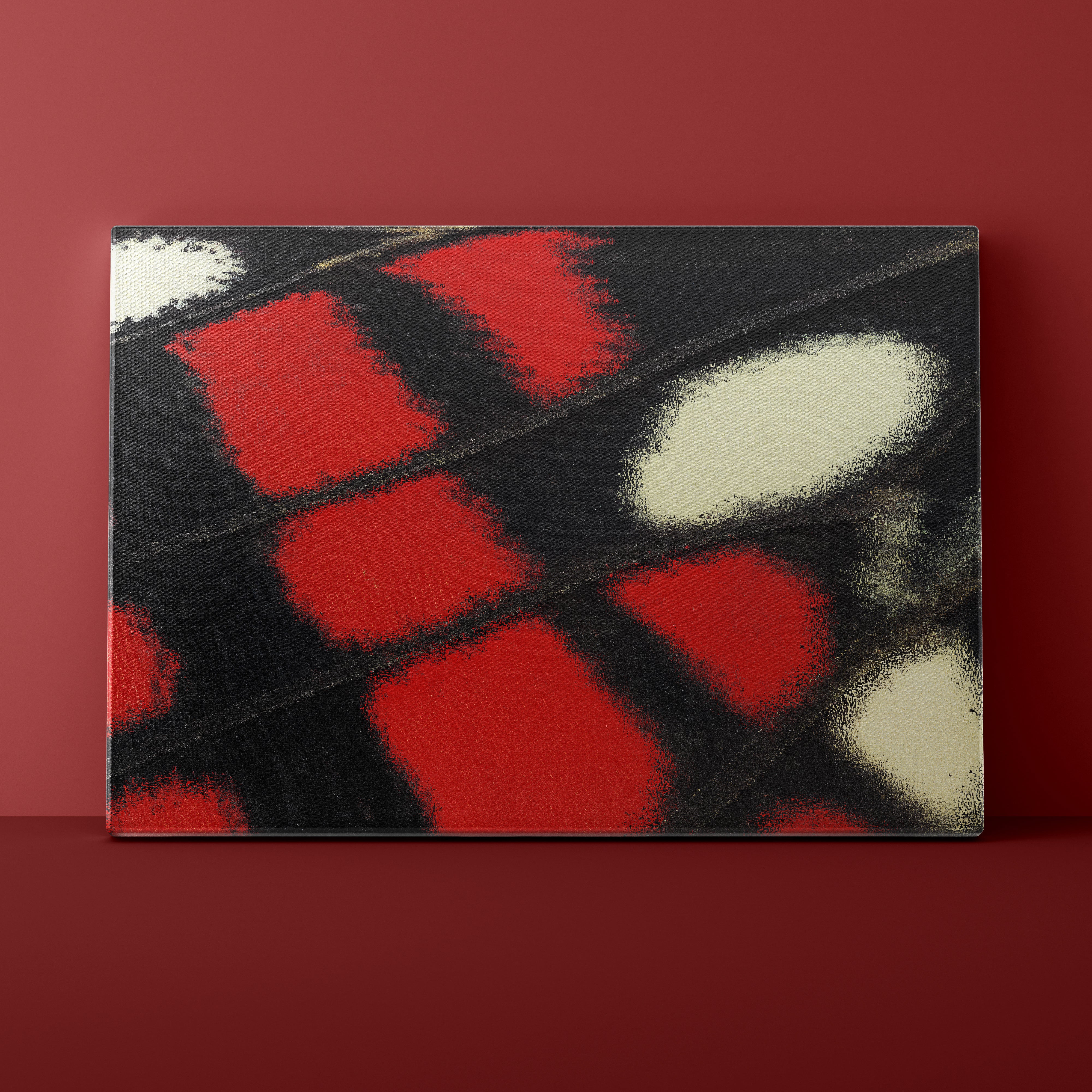 Abstract art piece with red, black, and white colors on a dark background