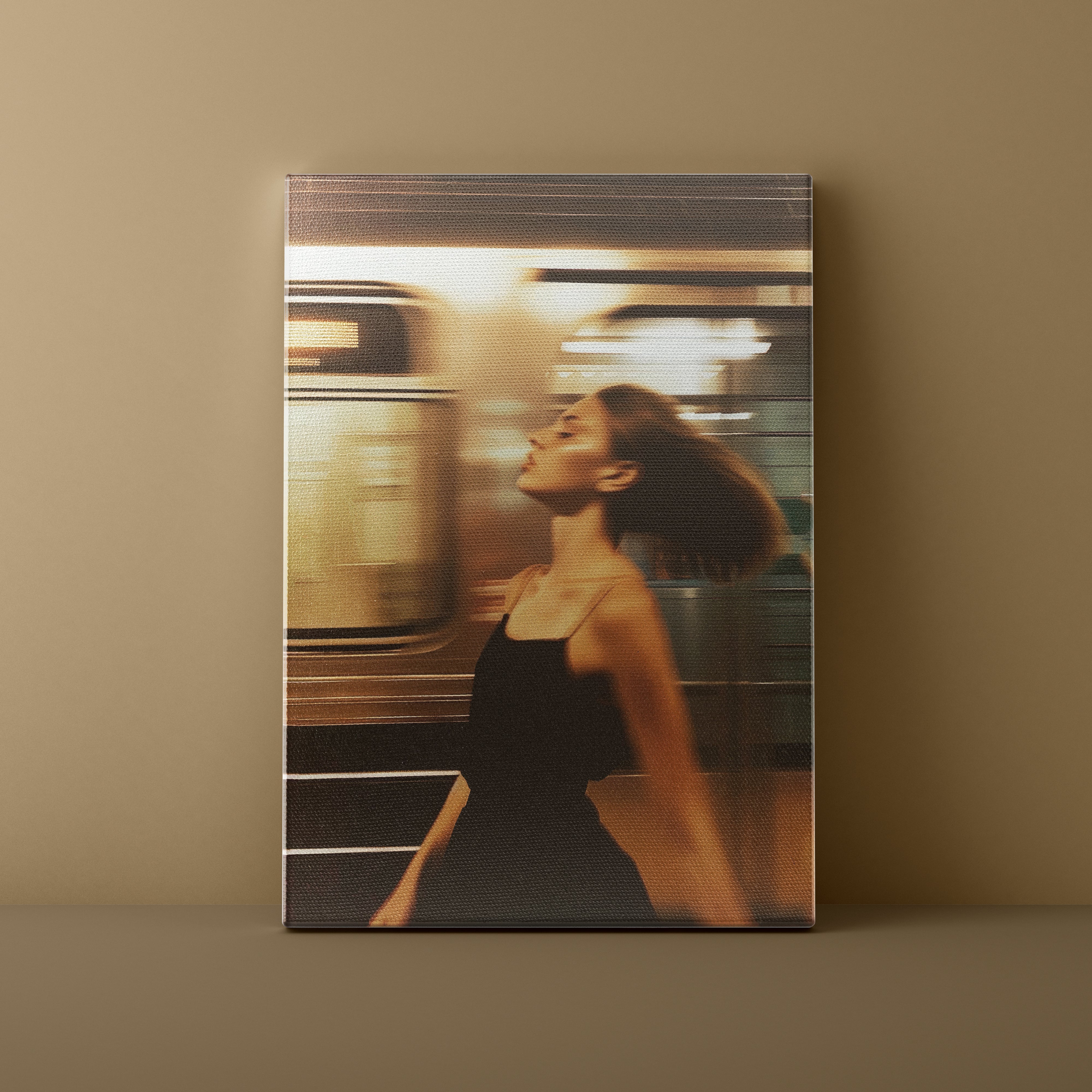 Framed photograph of a woman standing in front of a blurred train on a wall.