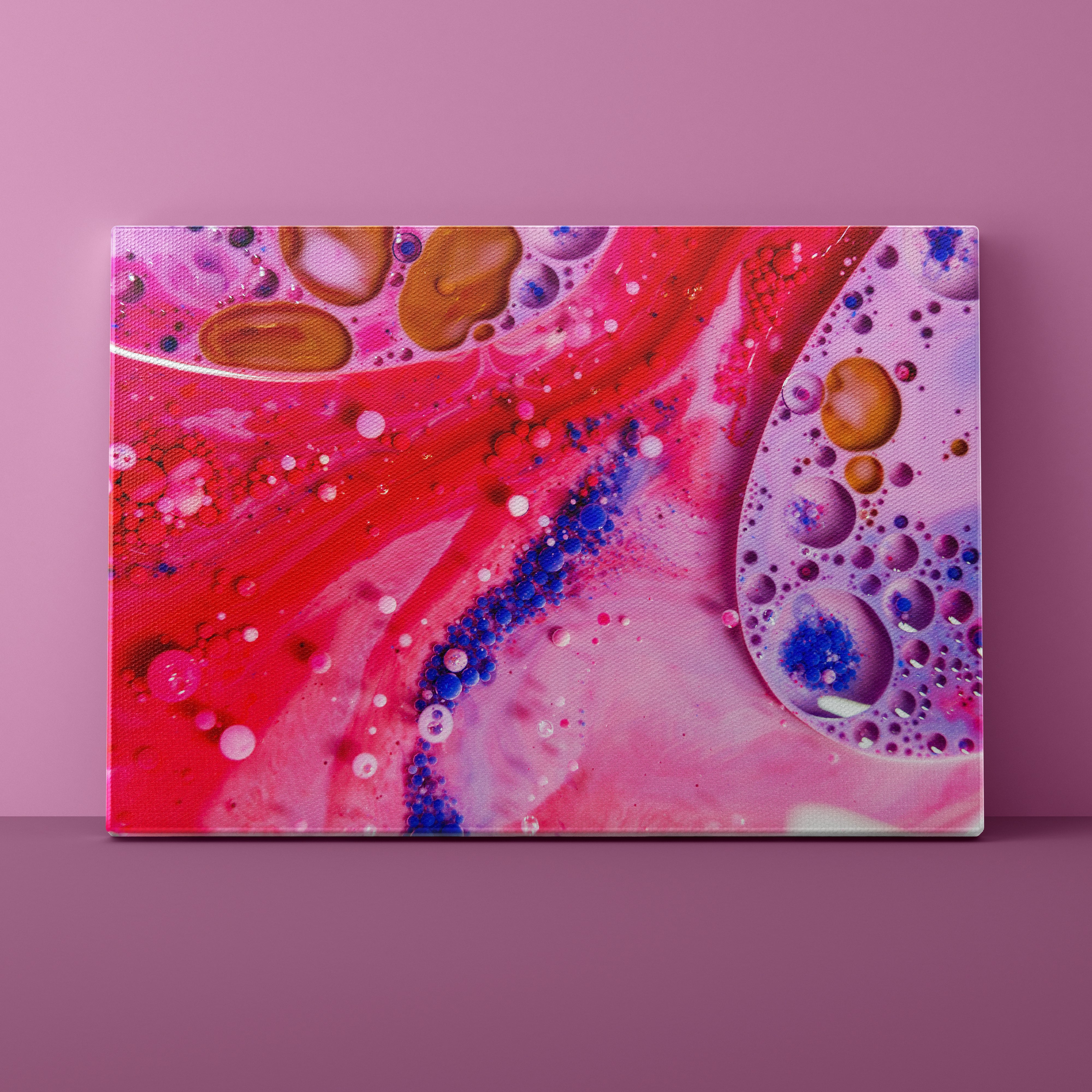 Abstract art canvas with pink, red, and blue colors on a pink background